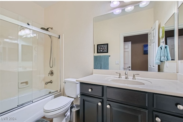 full bathroom featuring shower / bath combination with glass door, vanity, and toilet