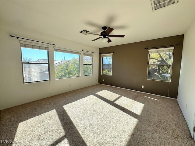 unfurnished room with carpet and ceiling fan