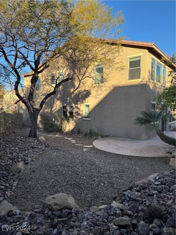 view of property exterior featuring a patio area