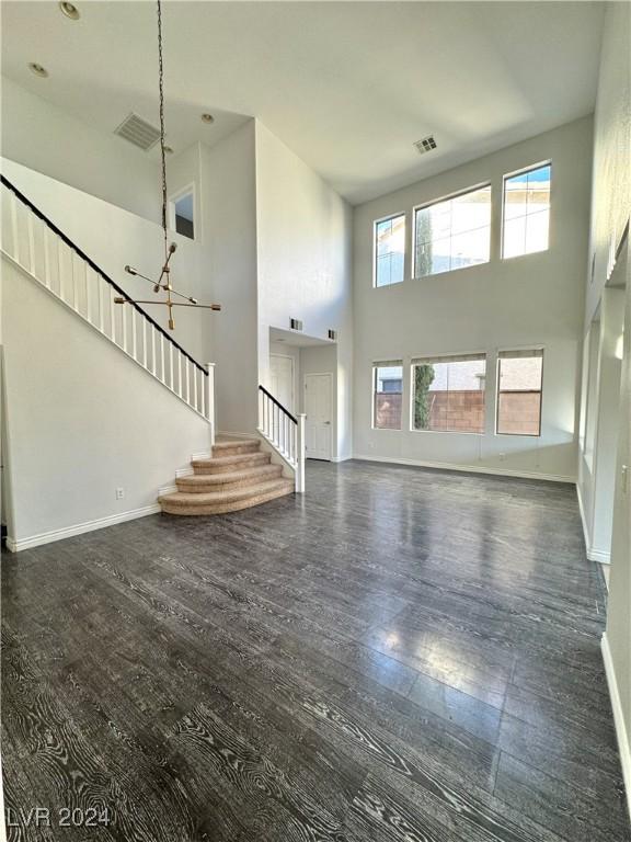 unfurnished living room with a high ceiling