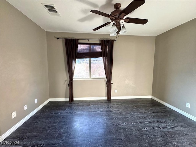 spare room with dark hardwood / wood-style flooring and ceiling fan