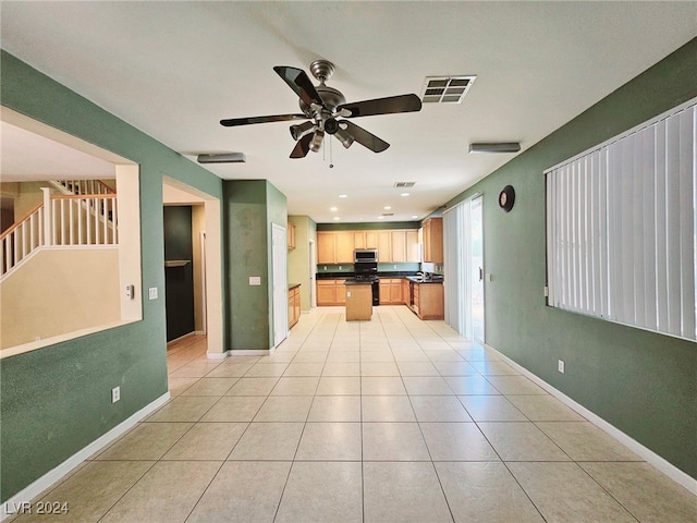 kitchen featuring light brown cabinets, black range with gas stovetop, light tile patterned floors, and ceiling fan