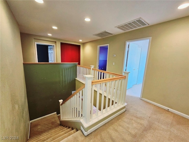 stairs featuring carpet floors