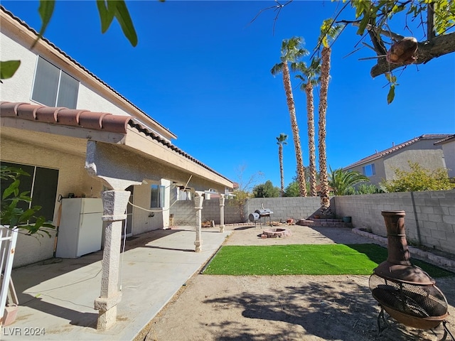 view of yard with a patio and a fire pit