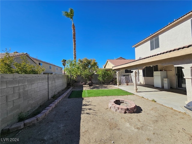 view of yard with a fire pit and a patio