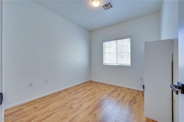 empty room with light hardwood / wood-style flooring