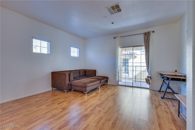 sitting room featuring a wealth of natural light and light hardwood / wood-style flooring