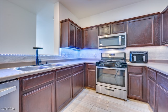 kitchen featuring sink, appliances with stainless steel finishes, and tasteful backsplash