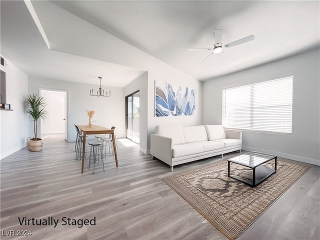 living room featuring hardwood / wood-style floors, plenty of natural light, and vaulted ceiling