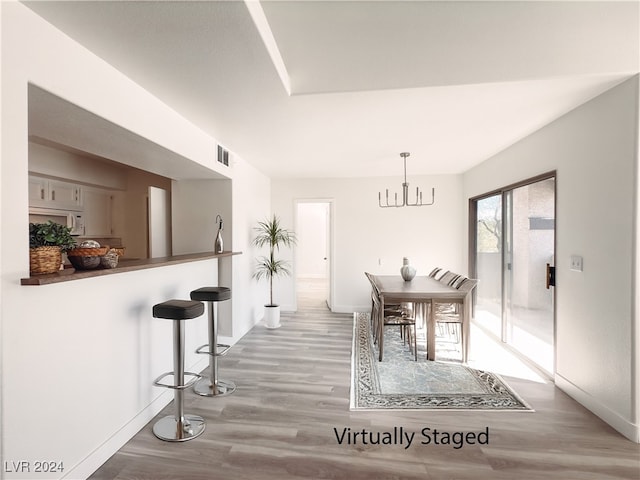 dining room featuring light hardwood / wood-style floors and a notable chandelier