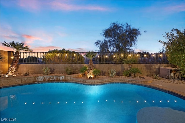 view of pool at dusk