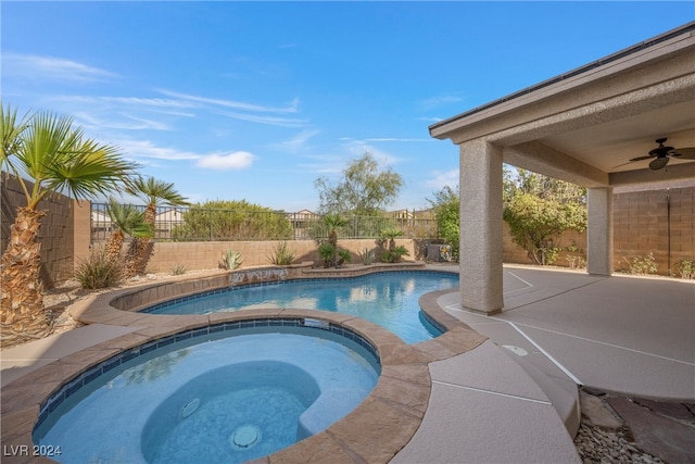 view of pool with ceiling fan and an in ground hot tub