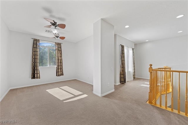 carpeted spare room with ceiling fan