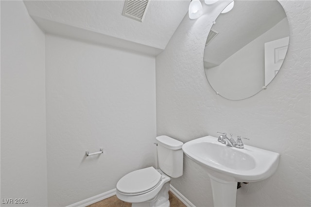 bathroom with tile patterned flooring and toilet