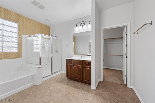 bathroom featuring shower with separate bathtub, vanity, and tile patterned flooring