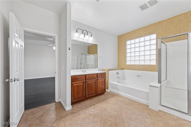 bathroom featuring tile patterned flooring, vanity, and plus walk in shower