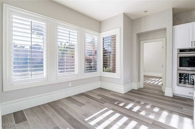 unfurnished dining area featuring light hardwood / wood-style flooring