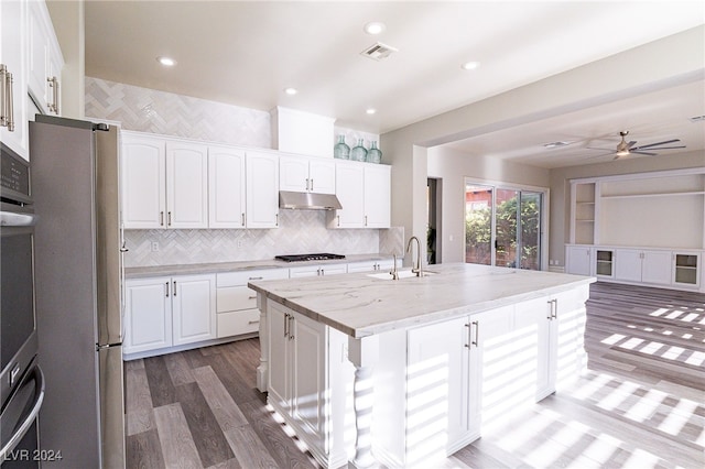 kitchen featuring white cabinetry, appliances with stainless steel finishes, and a center island with sink