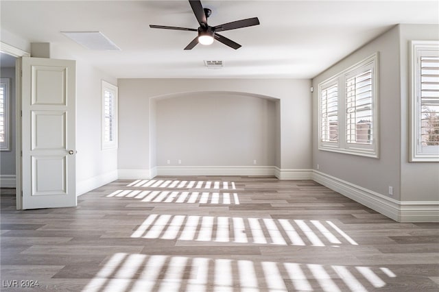 empty room featuring light wood-type flooring and ceiling fan