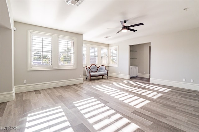 unfurnished room with ceiling fan and light wood-type flooring