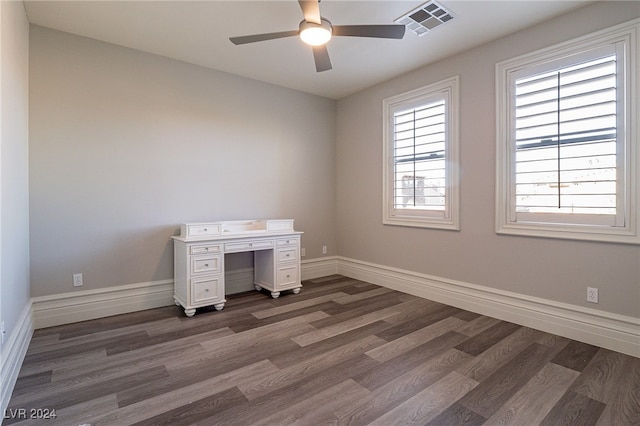 unfurnished office featuring ceiling fan and dark hardwood / wood-style flooring