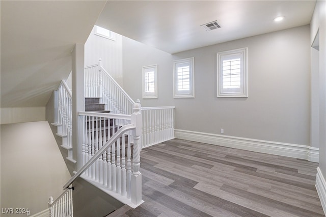 stairway with hardwood / wood-style flooring