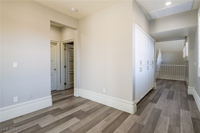 corridor with dark hardwood / wood-style floors