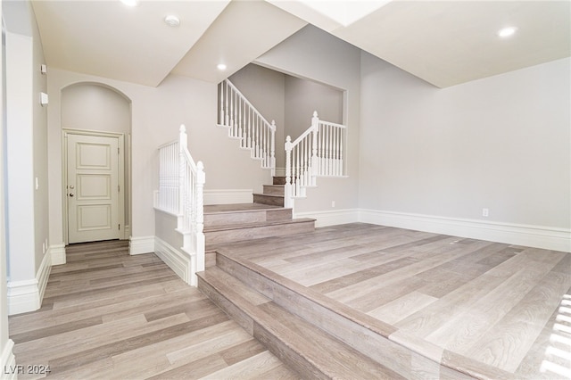 stairway with hardwood / wood-style flooring