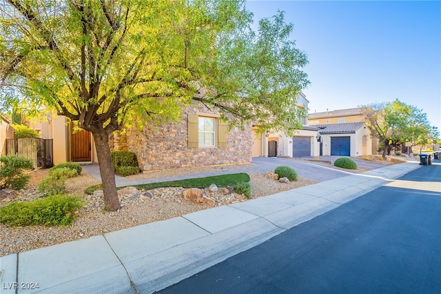 view of property hidden behind natural elements with a garage