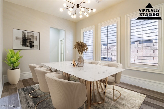 dining space featuring dark wood-type flooring and a chandelier