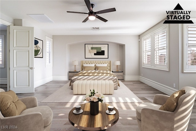 bedroom with light hardwood / wood-style floors and ceiling fan