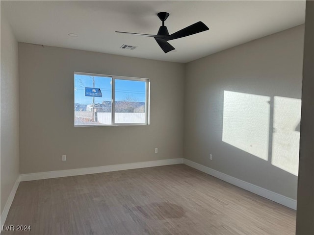 spare room with ceiling fan and light hardwood / wood-style floors