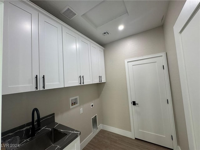 clothes washing area featuring sink, electric dryer hookup, hookup for a washing machine, cabinets, and dark wood-type flooring