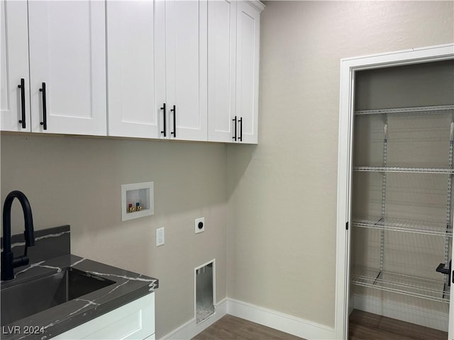 clothes washing area with hookup for an electric dryer, sink, cabinets, dark hardwood / wood-style flooring, and washer hookup