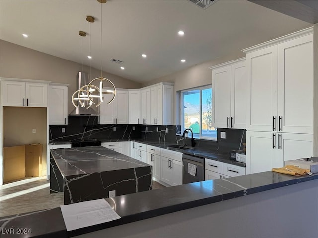 kitchen with dishwasher, hanging light fixtures, tasteful backsplash, lofted ceiling, and sink