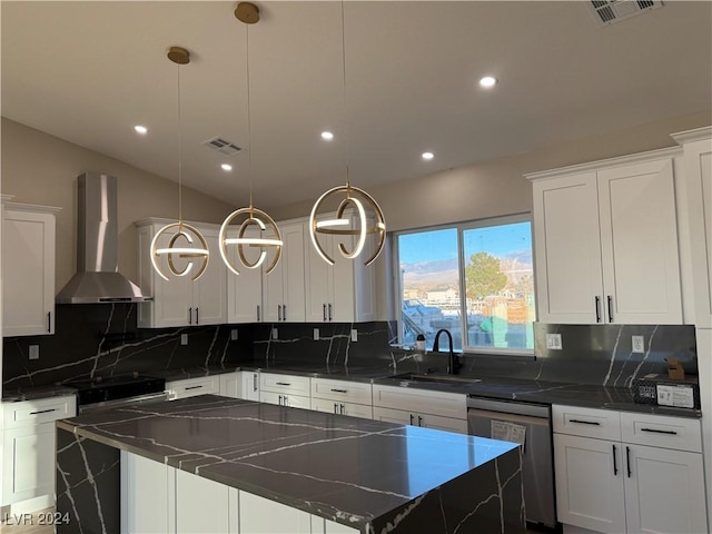 kitchen with sink, wall chimney exhaust hood, stainless steel dishwasher, hanging light fixtures, and a kitchen island