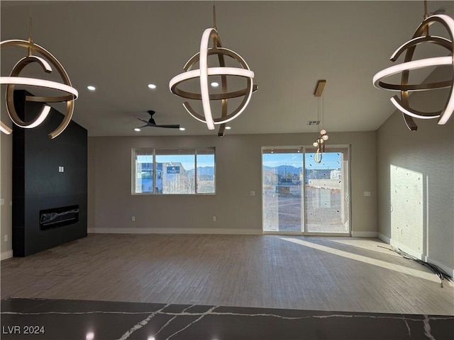 unfurnished living room with ceiling fan and hardwood / wood-style flooring