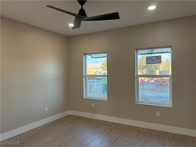 spare room with wood-type flooring and ceiling fan