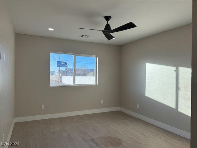 unfurnished room featuring ceiling fan and light hardwood / wood-style floors