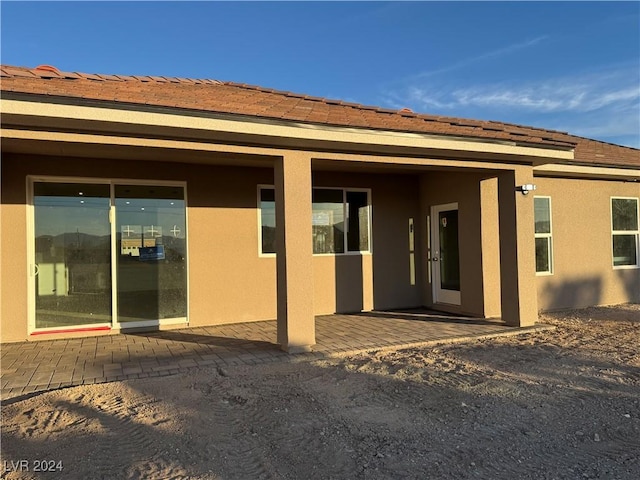 back of property with a patio