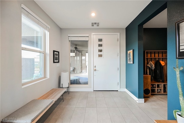 tiled foyer featuring ceiling fan