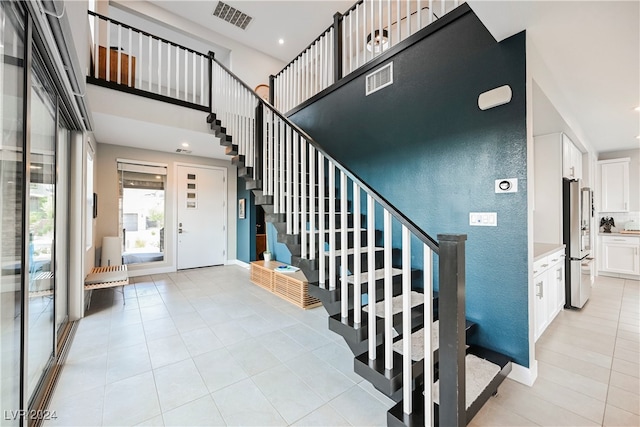 staircase featuring tile patterned floors