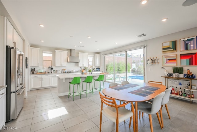 dining room with light tile patterned flooring and plenty of natural light