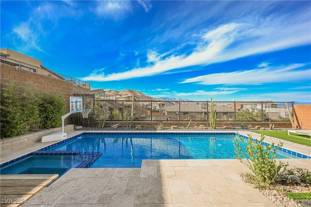 view of pool with an in ground hot tub and a patio area