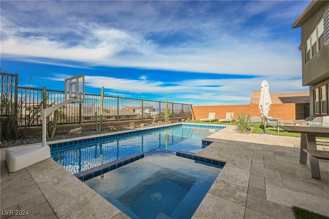 view of swimming pool with an in ground hot tub and a patio area