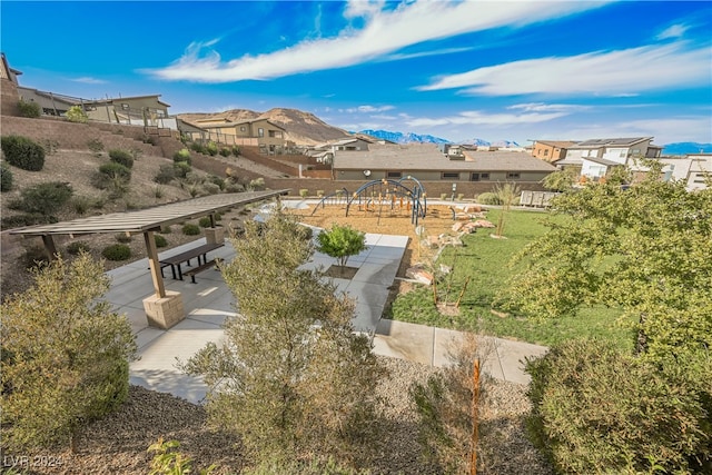 view of community with a yard and a patio area