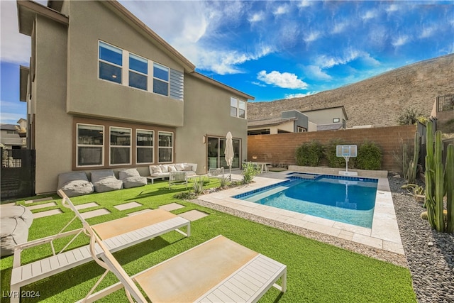 view of swimming pool with a yard, outdoor lounge area, and a patio