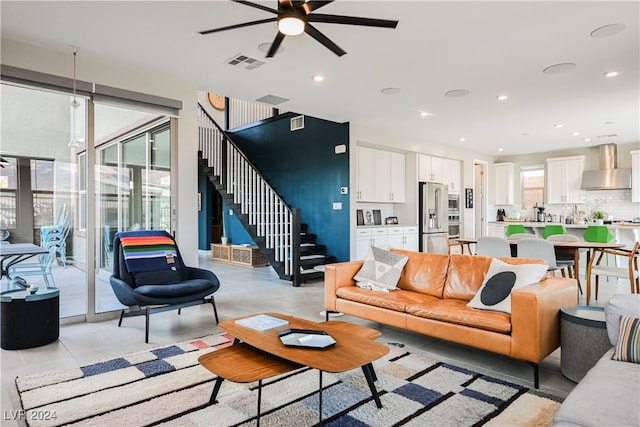 living room featuring ceiling fan and light tile patterned floors