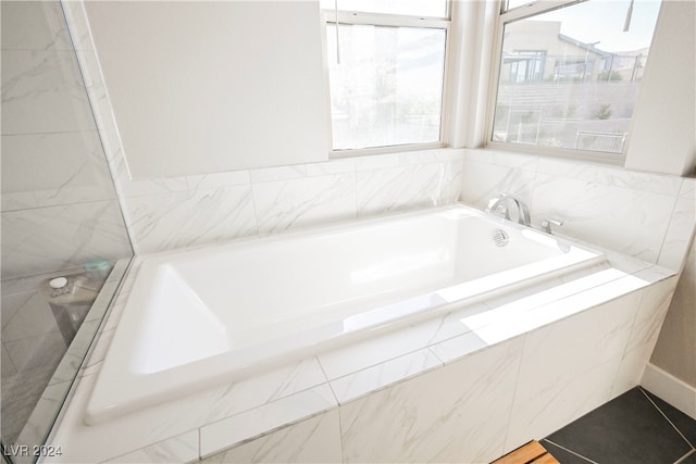 bathroom with tiled bath