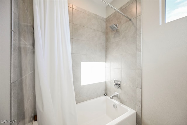 bathroom with shower / bath combo with shower curtain